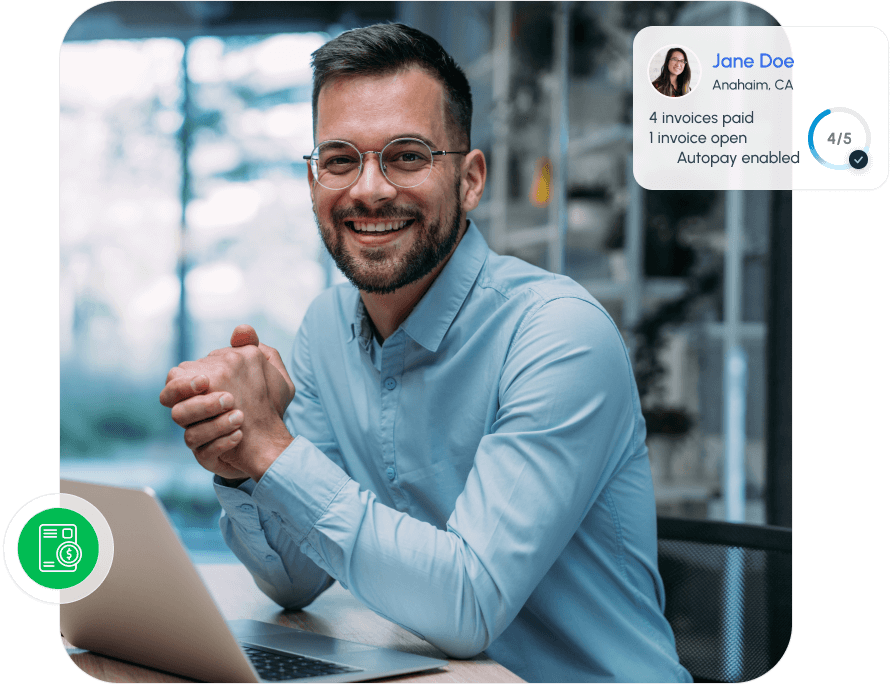 A smiling man in glasses sits at a desk with a laptop, while an on-screen overlay shows a user profile for “Jane Doe” from Anaheim, CA, listing invoice and autopay status.